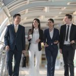 Business people walking and talk to each other in front of moder